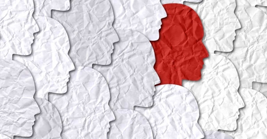 image of paper faces with one red race in the middle