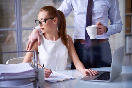 Man sexually harassing woman in workplace