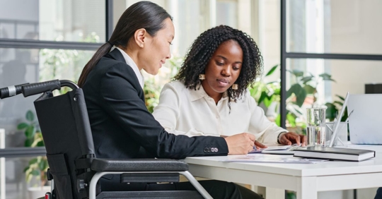 Asian female employer talking to an African American female employee