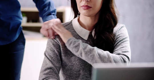 Businesswoman experiencing unwanted touching at the workplace