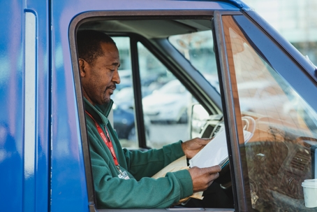 man in truck reading documents