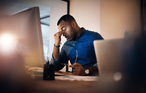 stressed employee in front of computer