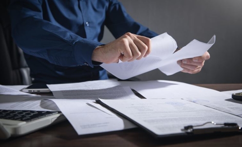 Businessman breaking contract at office.