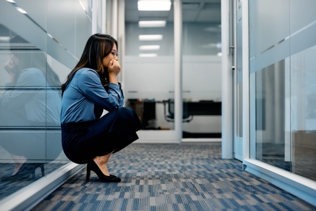 scared employee hiding in office hallway