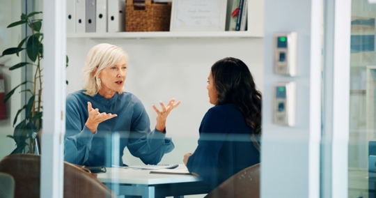 boss and employee in a serious discussion in an office