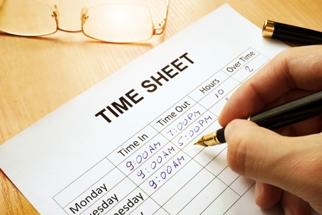employee logging in work hours on time sheet