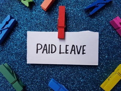 Paid leave writting on blue background.